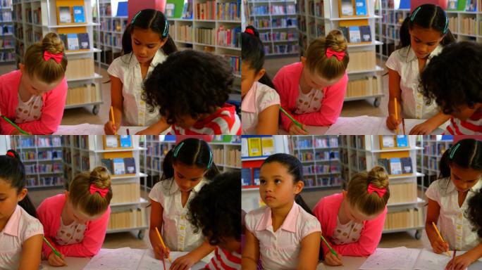 学校的孩子们在学校图书馆的桌子上一起学习