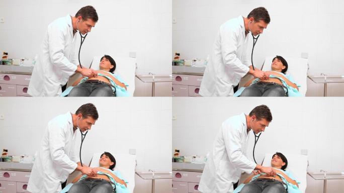 医生在检查室用听诊器检查腹部特写
