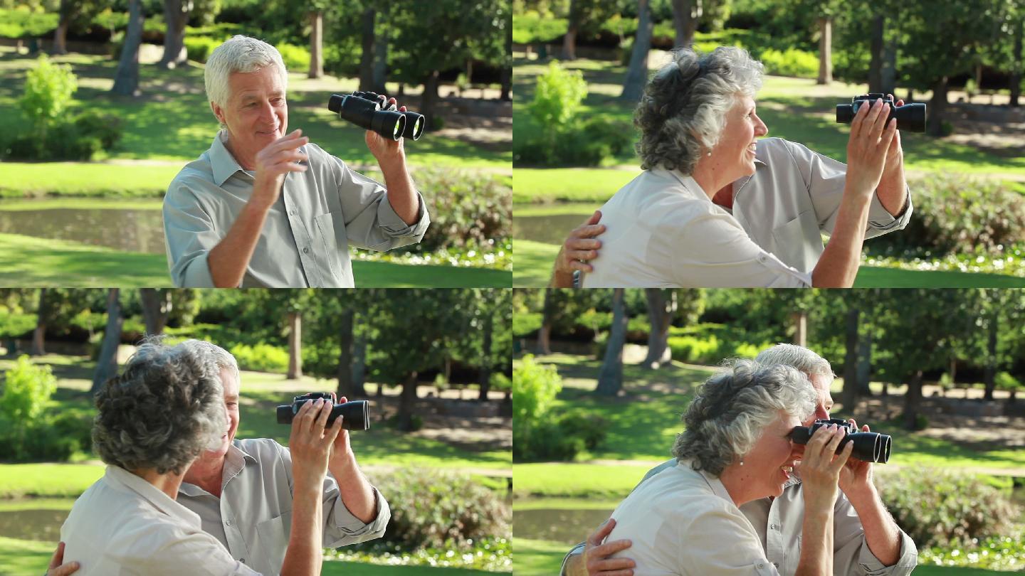 一对退休夫妇在乡下用望远镜看东西