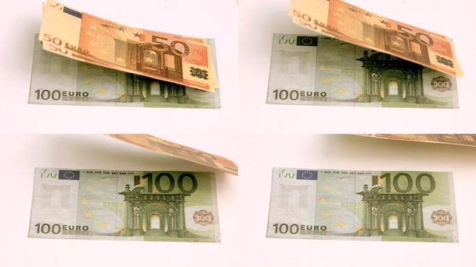 欧洲钞票在白色背景下以超级慢动作吹出