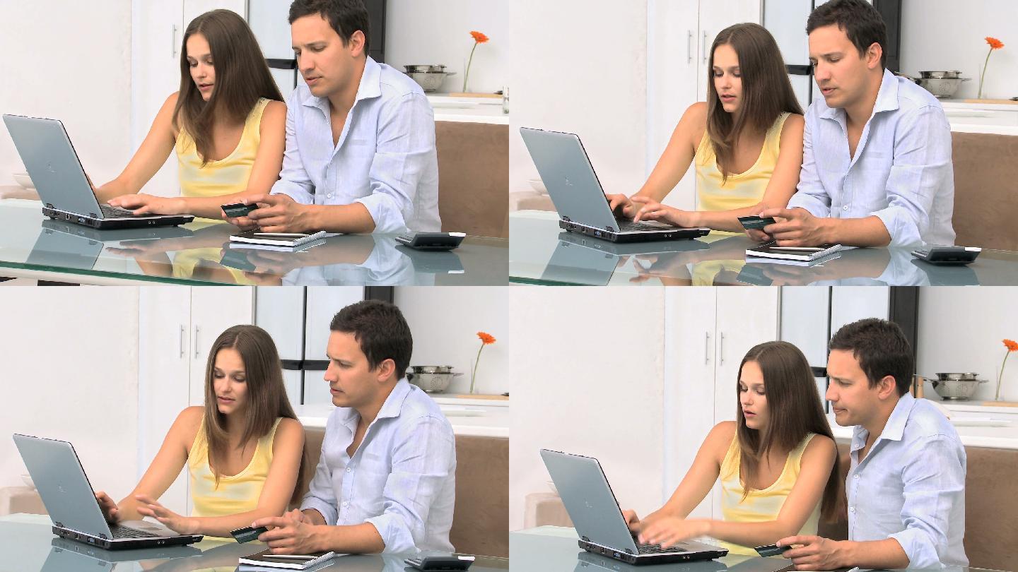 夫妻坐在一起用电脑购物特写