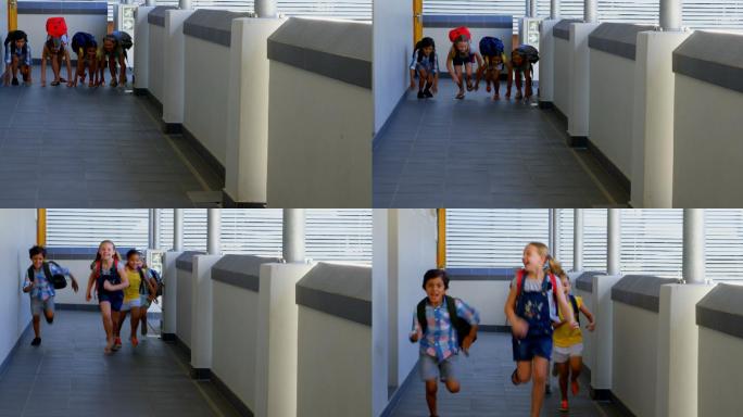 小学生拿着书包在学校的走廊上跑