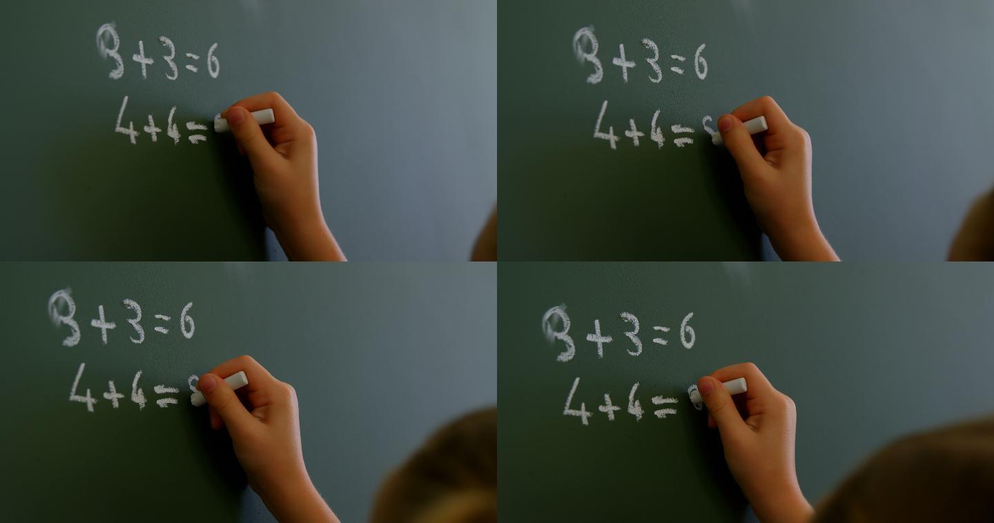 女学生在教室里用粉笔在黑板上写4k