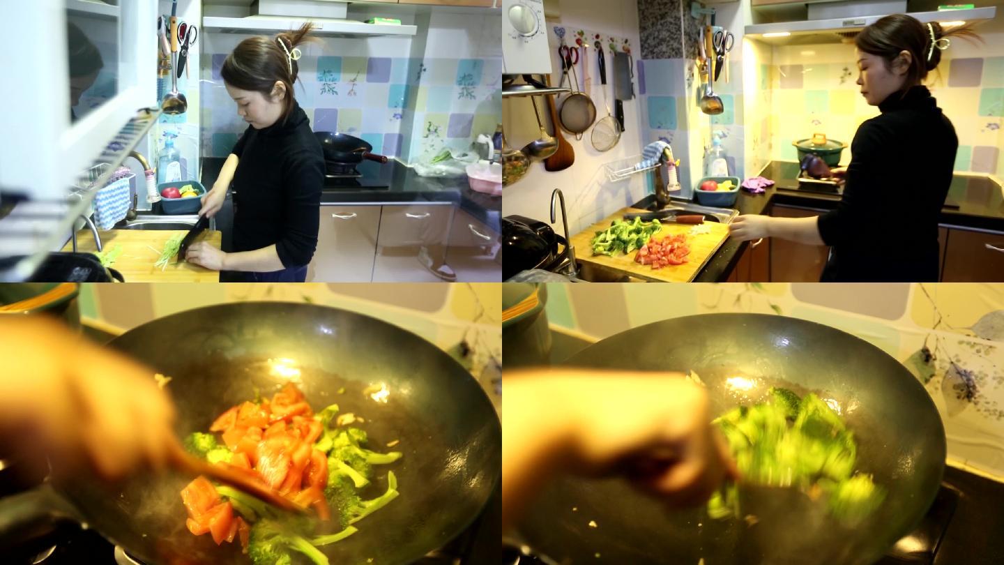 妇女在厨房炒菜切菜做饭勤劳持家