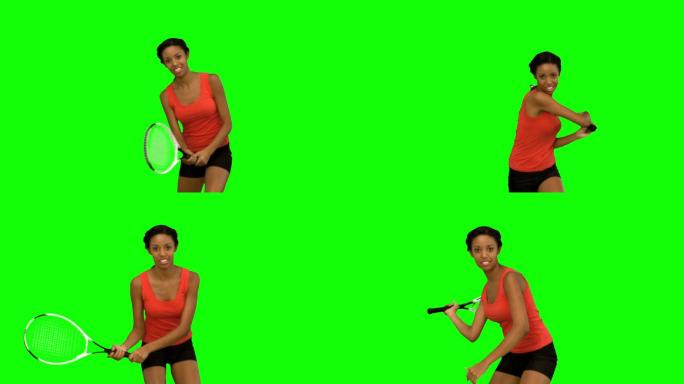 女人在绿色背景下练习打网球特写