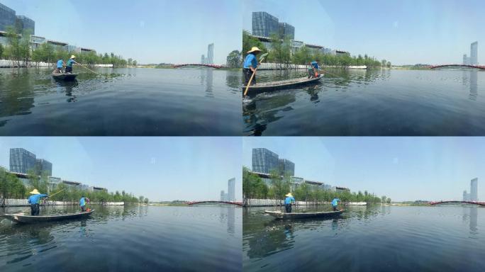 城市公园环卫工人划船水面清理杂物杂草