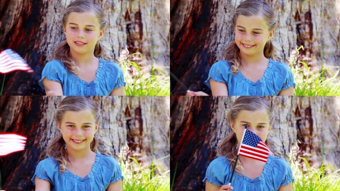 女孩在公园里玩美国国旗