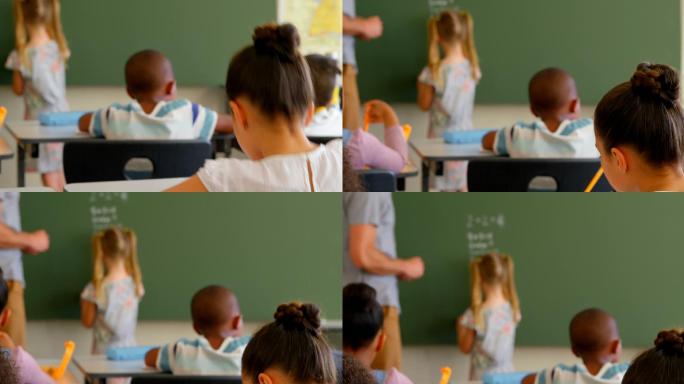 年轻的白人男教师和女学生在黑板上用4k解数学题