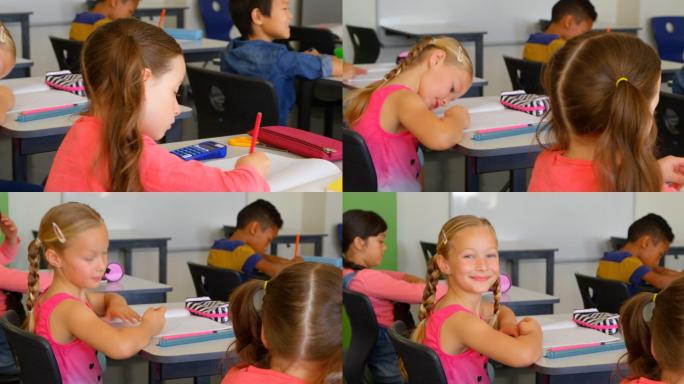 快乐的白人女学生在课桌上学习在学校4k