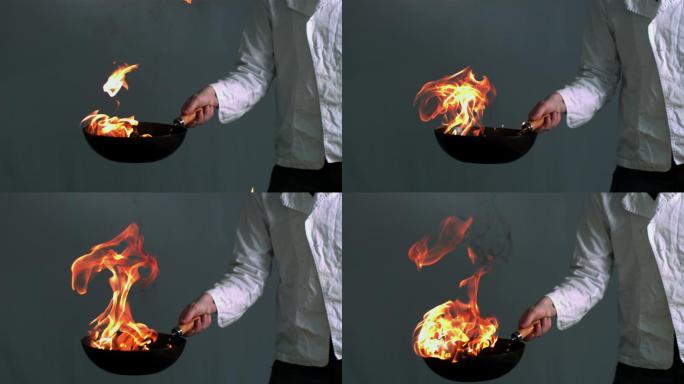 燃烧的锅由厨师拿在慢动作
