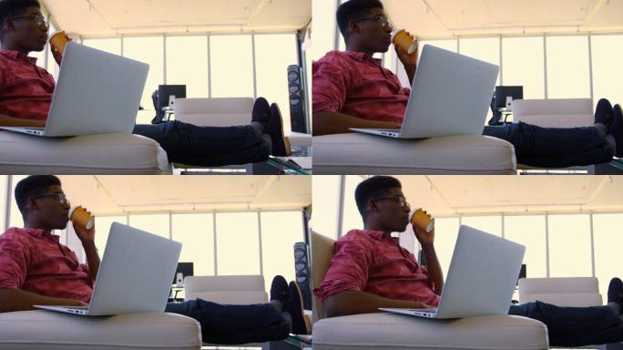 英俊的非裔美国男性行政人员使用笔记本电脑在现代办公室4k