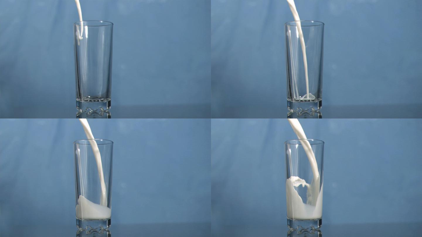 牛奶倒入玻璃杯慢镜头，在蓝色背景下