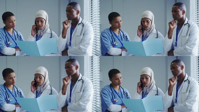 正面视图中东女医生与她的同事在医院用手机交谈