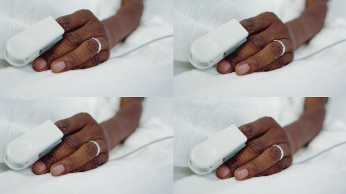 非裔美国男性病人在医院病房的脉搏血氧仪特写