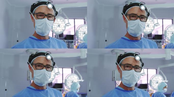 特写白种男医生站在外科大灯在手术室在医院