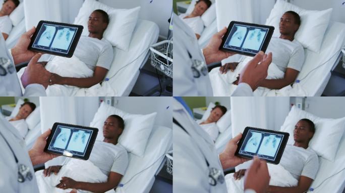 白人男性医生的特写看x光报告的数字平板在病房