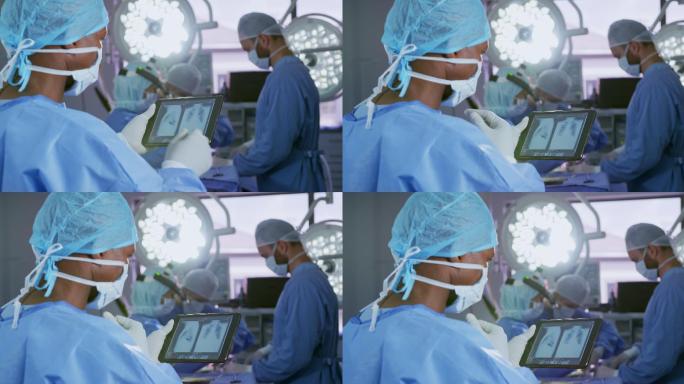 特写的非洲裔美国男性外科医生使用数字平板电脑在手术室在医院a