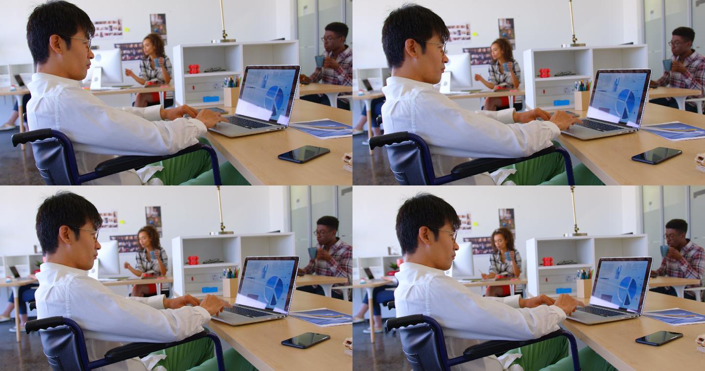 残疾的亚洲男性高管在现代4k办公桌边使用笔记本电脑