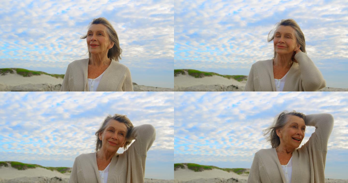 活跃的白人老女人站在沙滩上