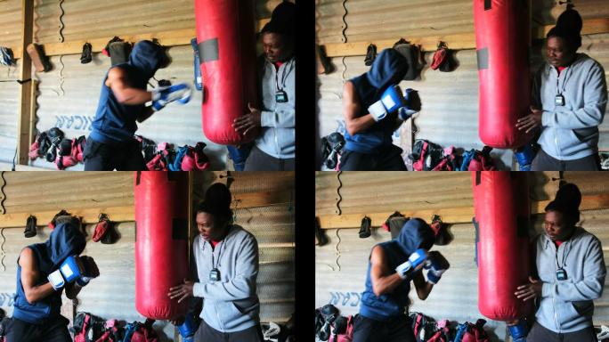 非裔美国男拳击手练习拳击与教练在健身工作室4k