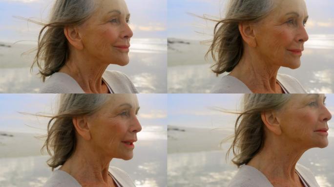 活跃的白人老女人站在沙滩上
