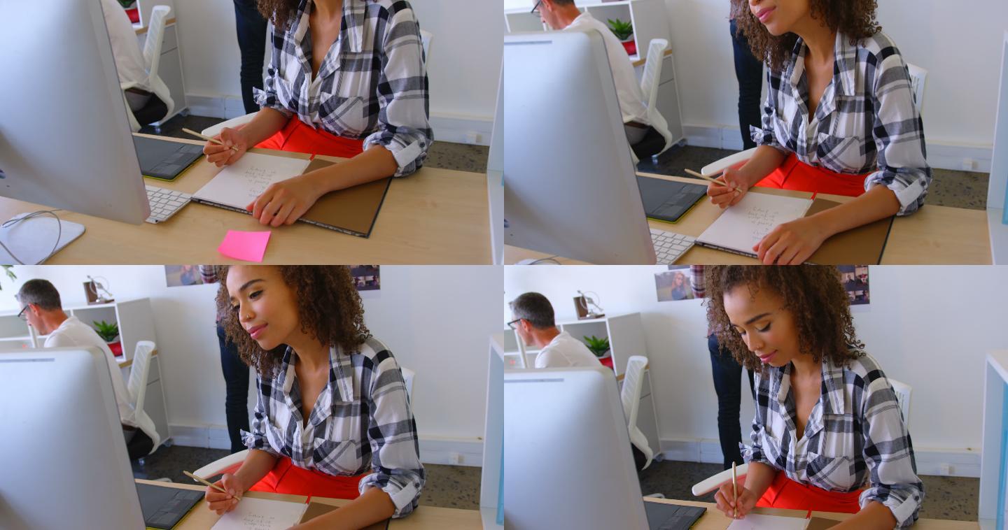 漂亮的混血女高管在现代4k办公室的记事本上写字