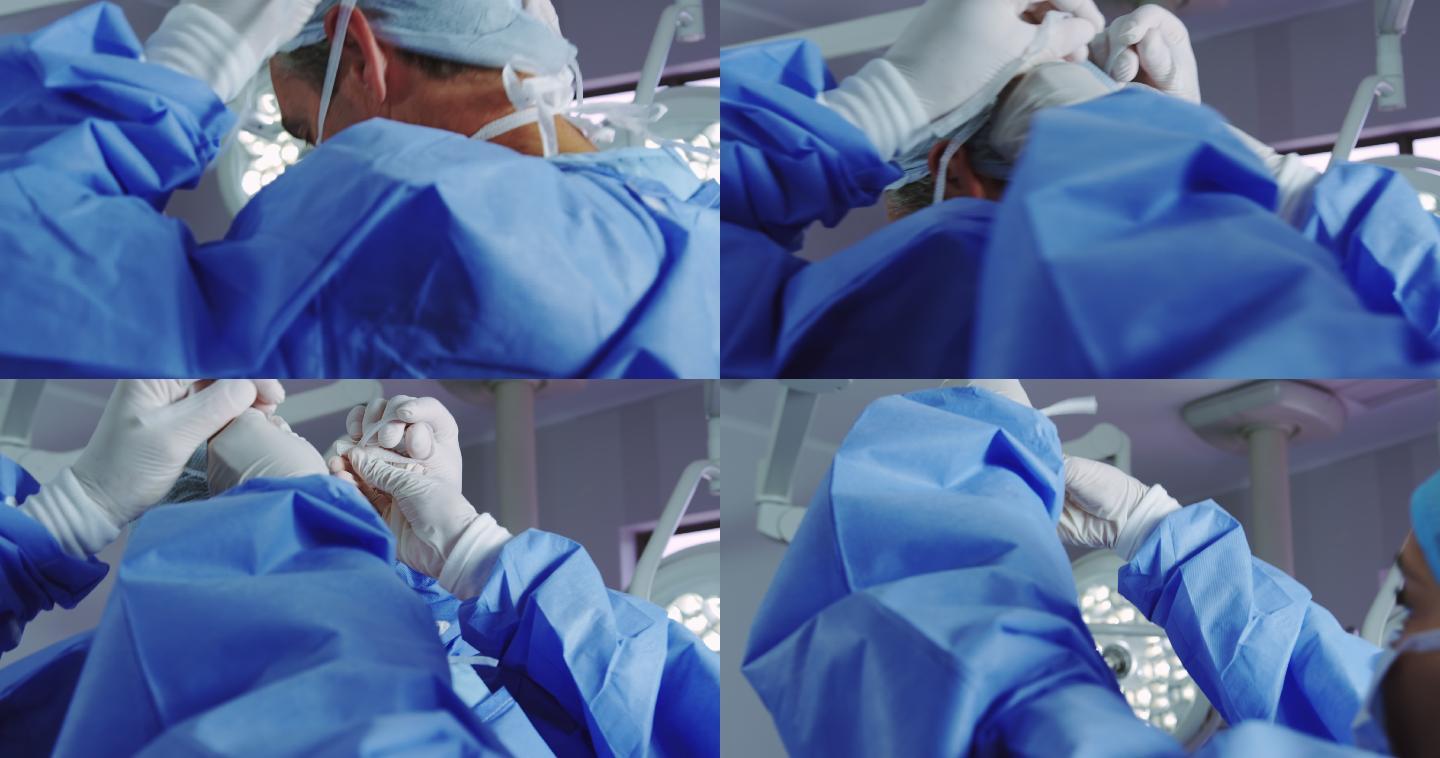 女医生在手术室帮助男医生戴口罩的特写