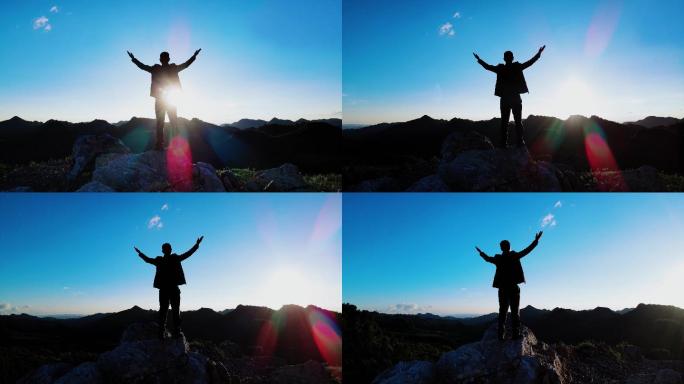 男人山顶张开双臂拥抱蓝天成功登顶登山素材