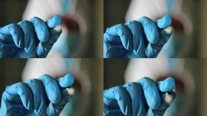 核酸检测拿棉签提取唾液的手特写