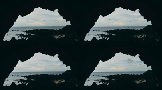 游客在苍穹岩石下的海边游玩儋州龙门激浪