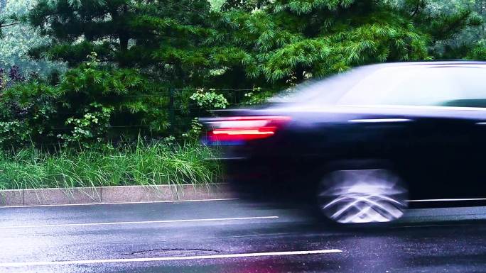 雨后马路飞驰而过的轿车