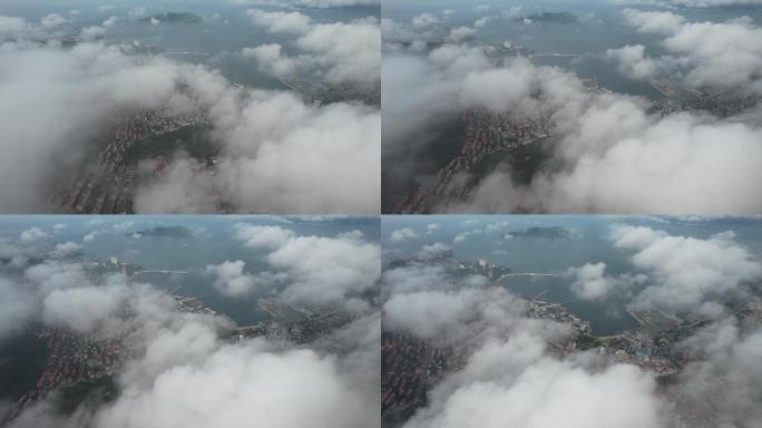 航拍飞云之下的威海湾和城市街区