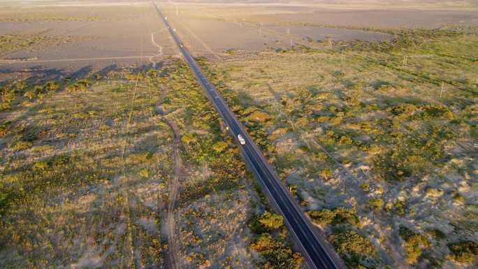 航拍行驶在笔直公路上的货车