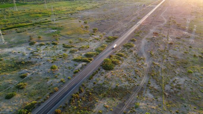 航拍行驶在笔直公路上的货车