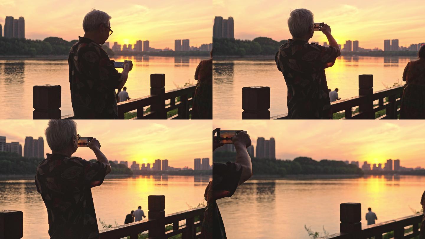 夕阳下拍照的老人背影4K100帧素材