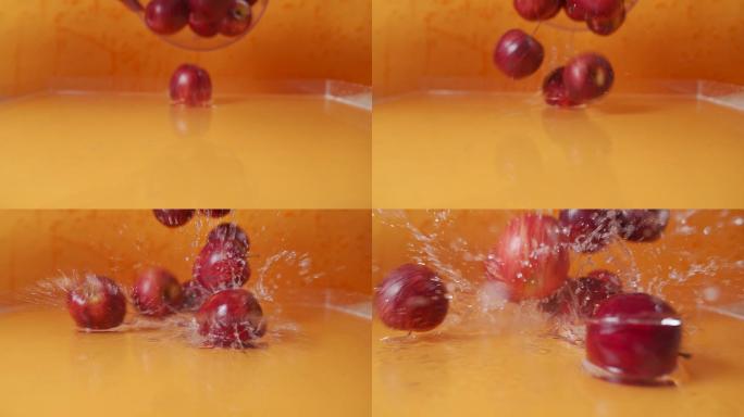 4k慢速红苹果水果掉落水面上溅起水花