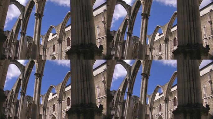 华丽的拱门，一座古老大教堂的石门；背景是大教堂的建筑；白云在蓝天上飘动。