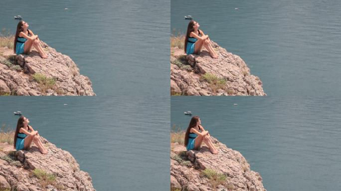 乌克兰克里米亚Balaklava海边悬崖边休息的年轻女子