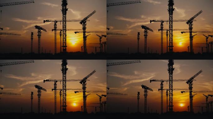 傍晚夕阳下的工地施工塔吊吊车