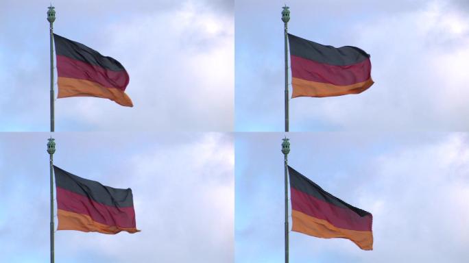 多云的天空前德意志联邦共和国的国旗。