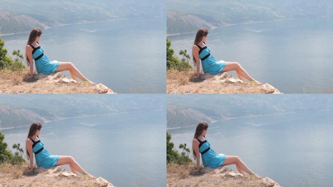 坐在黑海附近悬崖边上的年轻女子