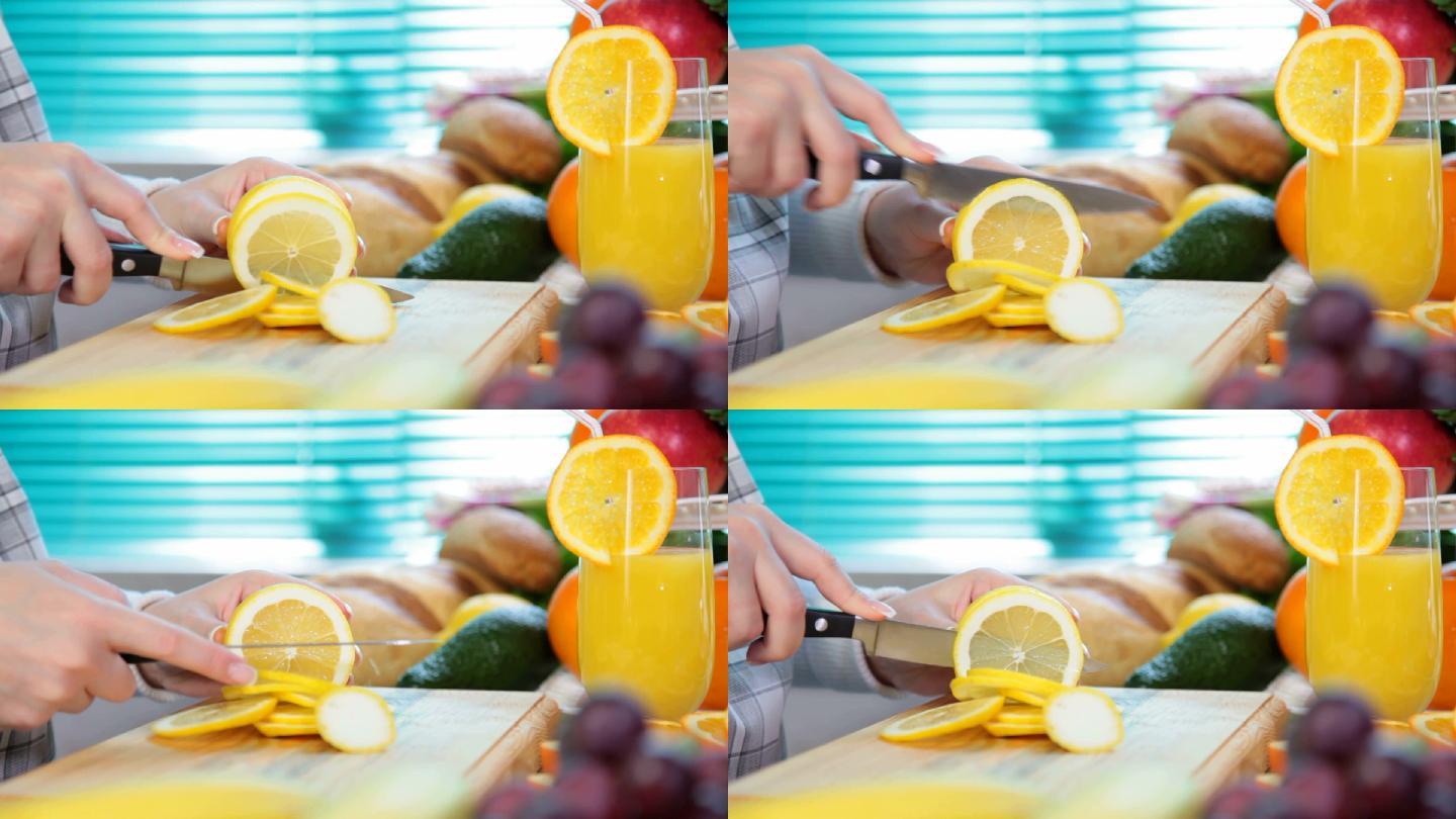 女人用手在砧板上切柠檬