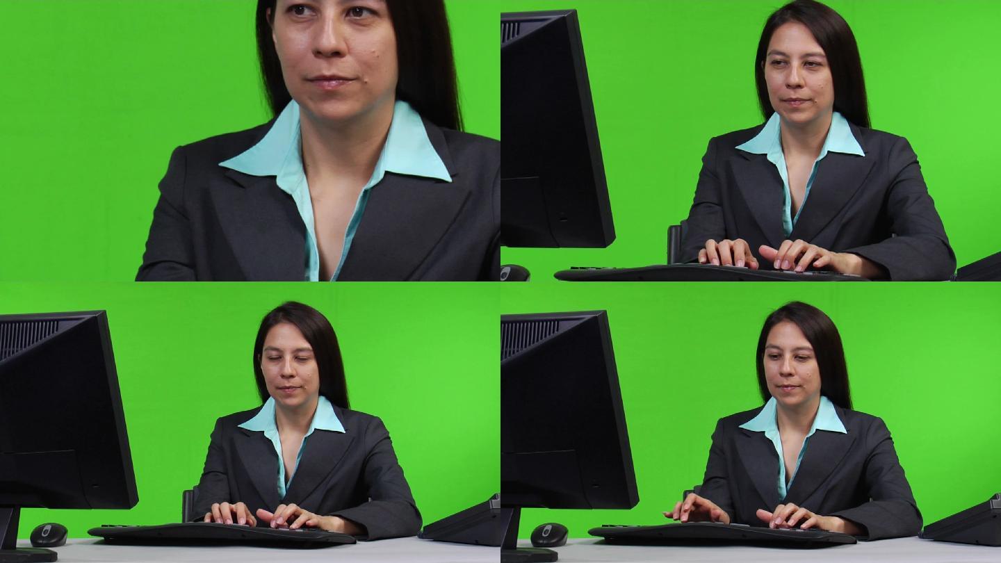用绿屏版在电脑上工作的年轻女商人——用绿屏版在电脑上打字的年轻女商人