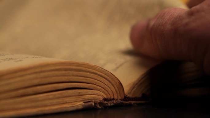 人的手翻过书的一页。