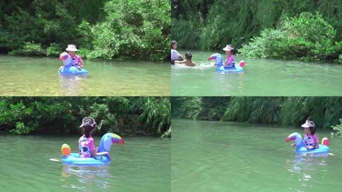 夏天坐着游泳圈在小河里玩水的女孩子