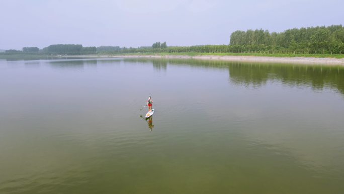 在河上直立做单桨冲浪的女孩