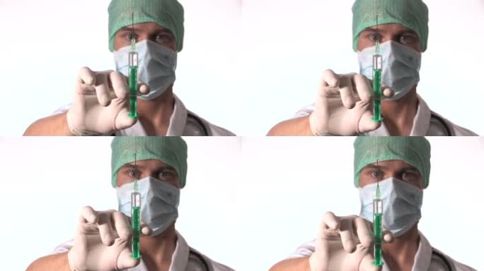 一位医生举起一只手，将抽出的针剂注射到摄像机中。
