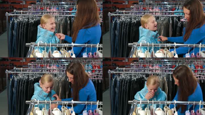 母亲和女儿在服装店挑选衣服，试穿夹克