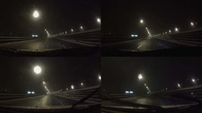 汽车穿过暴风雪在夜间道路上行驶