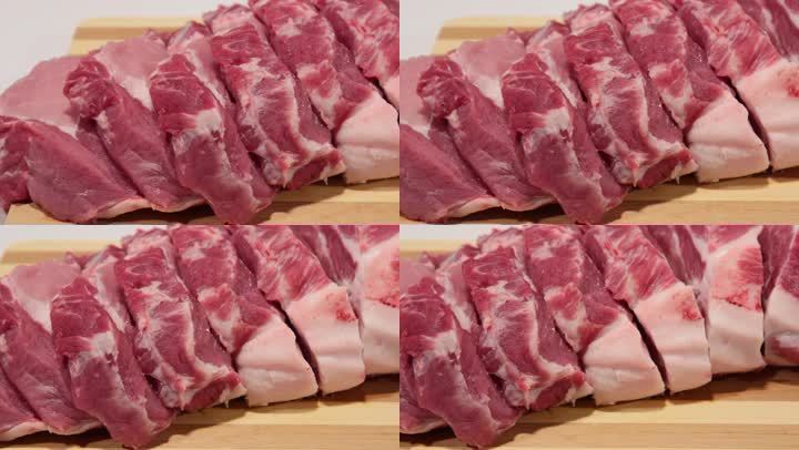 把新鲜猪肉切成薄片放在木砧板上